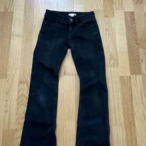 Svarta bootcut jeans från Gina Tricot - Snygga svarta bootcut jeans från Gina Tricot. De har en klassisk femficksdesign med knappar bak och en bekväm passform. Säljer för att de är för små och då inte används längre❤️
