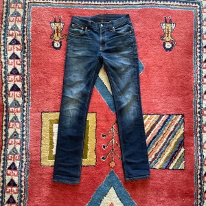 Nudie jeans Thin Finn - Snygga Nudie jeans i modellen Thinn Finn, storlek 31/32 men skulle säga att de kan upplevas  någon storlek mindre, Mått: Ytterbenslängd,ca 106cm….Midjebredd, ca 39cm…… benöppning, ca 17cm+-….. Slim/skinny fit. Väldigt fina ”fades”. Meterialet kan upplevas någorlunda ”stretchigt” …….Bara att höra av sig för fler bilder/ mer information. Pris inte fast