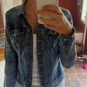 Blå jeansjacka med nitar från Culture - Snygg blå jeansjacka från Culture med silvriga knappar och paljetter på ena bröst fickan och över axlarna där bak💗