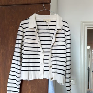 Randig kofta Sézane med silvriga knappar - Superfin kofta från Sézane i vitt med svarta ränder. 