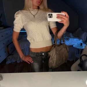 Vit cream färgad tröja - Superfin vit cream färgad tröja med quiltat mönster och korta ärmar. Tröjan har ribbade muddar vid ärmslut och midja, och en rund halsringning. Perfekt för dig som gillar en söt och trendig look🩷