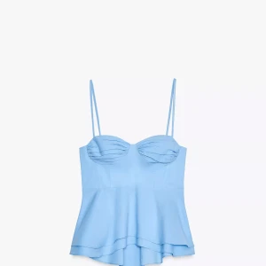 Ljusblå korsett-topp med tunna band - Supersöt ljusblå korsett-topp med tunna axelband och volangig nederdel. Kuporna har snygga rynkade detaljer som ger en feminin vibe. Perfekt för dig som vill ha en trendig och luftig topp till sommaren.