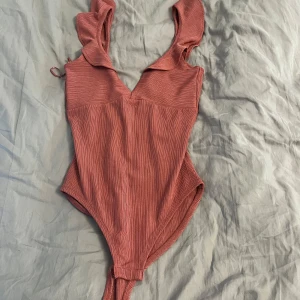 Rosa body  - Väldigt fin rosa body som aldrig är använd 