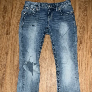  Miss Me Jeans - Säljer ett par blå jeansbyxor från Miss Me med slitningar och hål på benen. Inga defekter, strl W26. Midjemått- 36cm | Ytterbenslängd- 95cm |Innerbenslängd- 74cm | Skriv gärna vid ytterligare frågor!💘