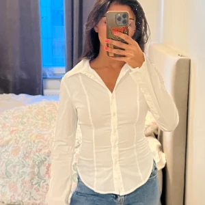 Vit figursydd skjorta med långa ärmar - skjorta från bershka med prislapp.