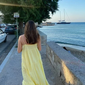 Ljusgul långklänning med tunna axelband - Säljer en ljusgul långklänning med tunna axelband och flowy passform. Jag är 162 cm.