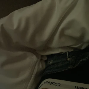 Vit långärmad skjorta i bomull - Säljer en klassisk vit långärmad skjorta i mjuk bomull. Skjortan har en enkel och stilren design med knappar framtill. Perfekt för dig som gillar en clean och tidlös look.