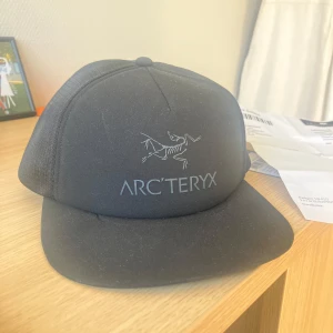 Svart Arcteryx keps - Aldrig använd, prislappen finns kvar! Jag säljer den för min lillebror ville inte ha den i present (går tyvärr inte att skicka tillbaka). Har kvitto och allt.   Köptes för 599