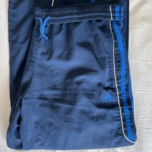 Adidas trackpants  - Mörkblåa adidas trackpants, fickor finns, perfekta till att dansa i och har resårband så kan sitta både low waist men även högre ifall man vill. De är stretchiga vid midjan så kan skjusteras i storlek. 
