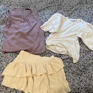 Kjol + 2 blusar - Volangkjol från Ginatricot, beige/vit, använd ett par gånger, M Ärmlös blus från MQ, syrenlila, 36 T-tröja med puffärmar från pure friday, vit, S 40kr/plagg eller 100kr alla tre plaggen