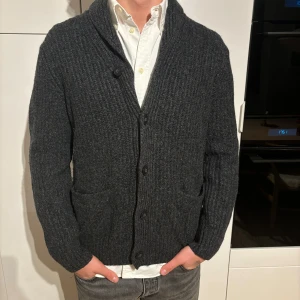 Grå kofta från H&M L (M) - Grå kofta från märket H&M, storlek L, men sitter som M. Bra använt skick, inga defekter. Modell på bild är 182/67kg. Hör av dig vid eventuella frågor! Mvh CAVI