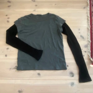 Brandy Melville tröja  - Säljer denna snygga grå svarta  T-Shirt tröjan från Brandy Melville då den inte kommit till användning.