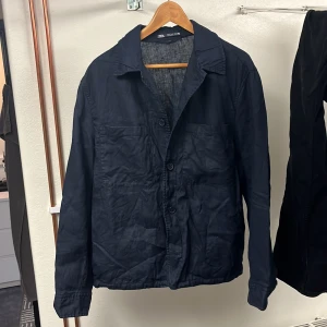 Blå  overshirt från Zara - Säljer en stilren svart overshirt från Zara. Den har en klassisk krage och knäppning framtill. Perfekt för lager-på-lager-stil och passar till många olika outfits.