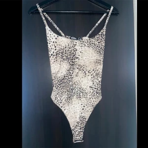 Leopardmönstrad bodysuit från Missguided - Säljer en supercool leopardmönstrad bodysuit från Missguided. Den har smala axelband och en tight passform som verkligen framhäver figuren. Helt ny!!! Säljer då den inte passar ❤️