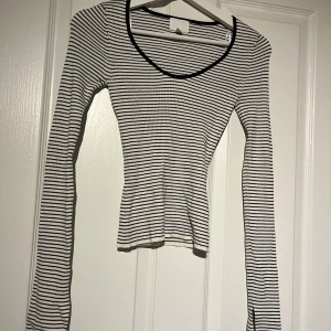 Randig långärmad topp - Säljer en superfin randig topp med lång ärm. Den är svart och vit med en snygg u-ringning. Perfekt för både vardag och fest! 
