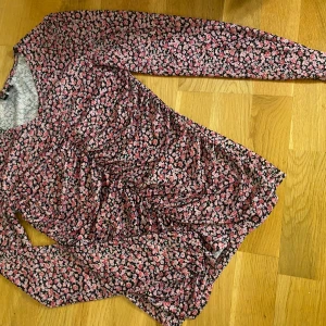 Blommig långärmad topp från Pieces - Säljer en superfin blommig topp från Pieces i storlek XS. Använd fåtal ggr