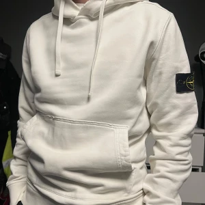 Stone island hoodie - Säljer killens vita Stone island hoodie, nypris 3499kr, lite sliten vid hals och händer men annars fint skick. Storlek M, säljer för 800kr + frakt eller lägg ett prisförslag🌟