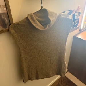 Beige ärmlös polotröja från Bik Bok - Säljer en stilren beige ärmlös polotröja från Bik Bok. Perfekt för lager-på-lager eller som den är. Tröjan har en mjuk och bekväm passform med en klassisk polokrage. Ett mångsidigt plagg för alla tillfällen.