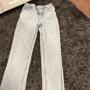 Ljusblå jeans från Evisu - Säljer ett par ljusblå jeans från Evisu med straight fit. högmidjade Jeans.   De har en klassisk femficksdesign och en läderpatch med logotyp på baksidan. Perfekta för en avslappnad stil.