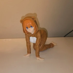 Bear Girl Onesie Sitting Anime Figurine - Anime Figure of Girl(?) in a bear onesie on her knees/all four sitting.