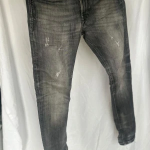 Grå jeans med slitningar - Snygga grå jeans med en cool slitningseffekt. De har en tight passform och är perfekta för en avslappnad stil. Klassisk femficksdesign och en bekväm midja. 28/30