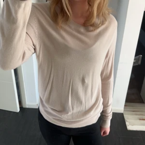 Beige långärmad tröja - Säljer en stilren och bekväm beige tröja med långa ärmar. Perfekt för både vardag och lite kyligare dagar. Tröjan har en mjuk och skön passform som gör den lätt att matcha med olika outfits.