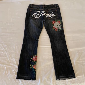 Rare vintage Ed Hardy jeans - Ed Hardy lowrise/lowwaist wide leg/bootcut vintage 2000s jeans, Mycket bra skick. Storlek 28 på lappen (inte EUR). Mått: midja - 42x2 cm, innerben 78 cm 