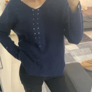 Mörkblå stickad tröja - Säljer en mysig mörkblå stickad tröja med v-ringning. Perfekt för kyliga dagar och passar både till vardags och lite finare tillfällen. Tröjan har långa ärmar och en avslappnad passform. Superbekväm och lätt att matcha med jeans eller kjol. Hör av dig vid intresse! 💙