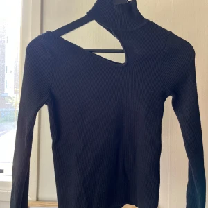 Tröja från Nakd - Svart tröja med utskärning vid ena nyckelbenet 