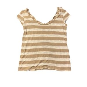 Topp med spetsdetaljer - Säljer denna söta beige och vit randig topp med korta ärmar och spetsdetalj i ryggen då den inte är min stil längre. Inget synligt slitage. Vet ej märke. Fler bilder eller frågor? Skicka dm 