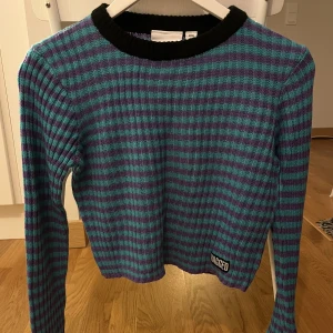 Ragged Jeans Stickad Tröja - Croppad stickad tröja från Ragged Jeans. Använd en gång. Turkosblå/lila ränder.