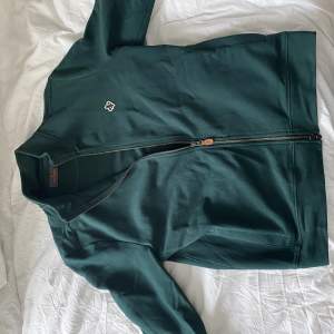 Mörkgrön Morris Stockholm Zip tröja. Använd en gång så 9/10 skick. Nypris 1500 kr, mitt pris 300 kr men kan gå ner vi snabb affär.