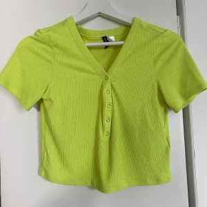 Neon gul t-shirt  - Neon gul t-shirt från H&M i storlek M. Använd en gång, fint skick!