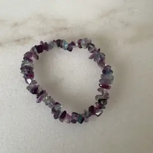 Ett armband utav kristaller i olika nyanser av lila. Aldrig använt.