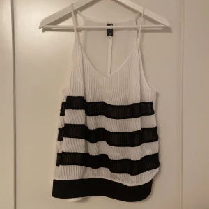G-Star Dressy tank top  - Black and white tank stop. Size S. Pleated and very lightweight. Has A V-neck. Great for spring. No stains/holes. Hartley ever worn.