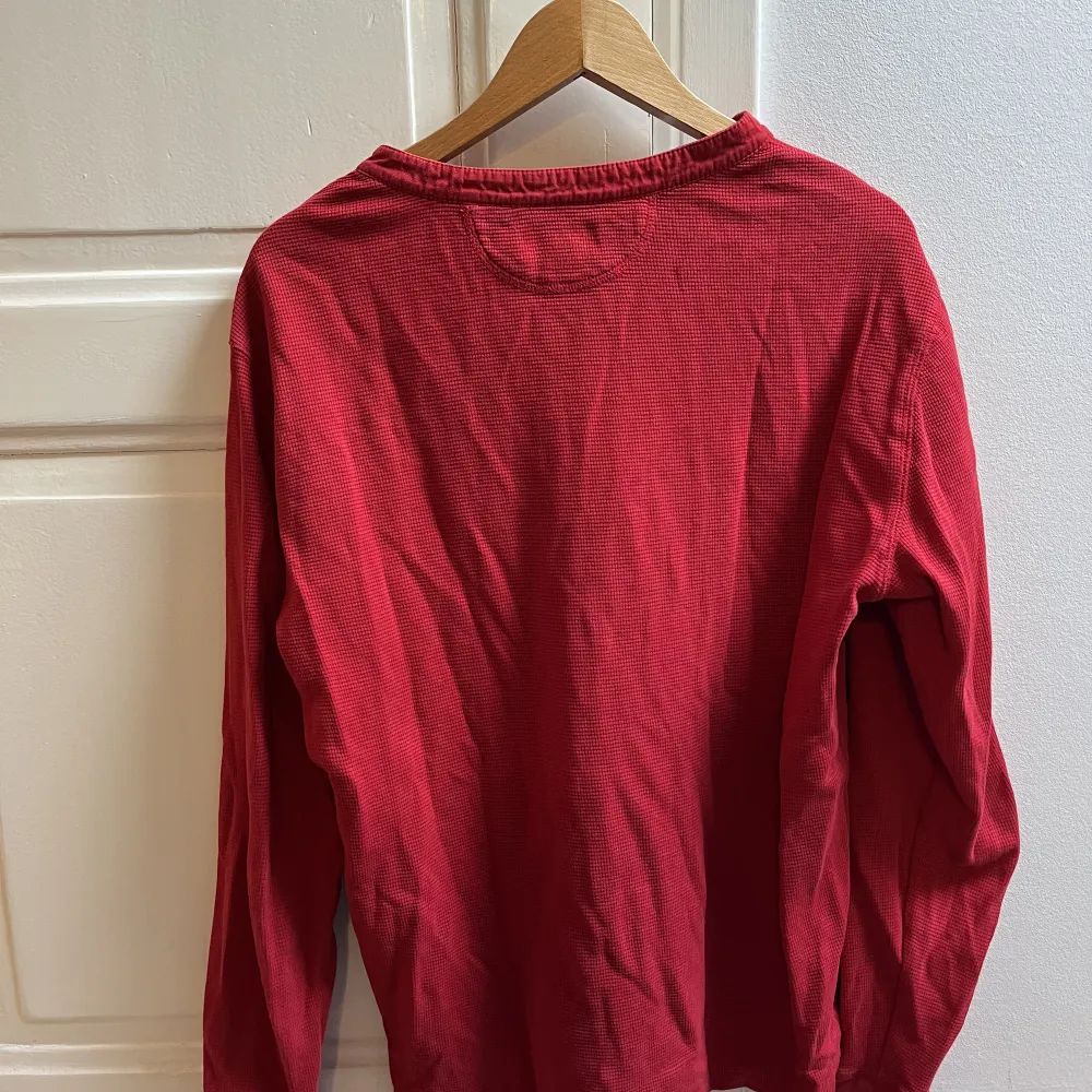 Röd långärmad tröja med svart märke. Kondition 10/10 knappt använd . Tröjor & Koftor.