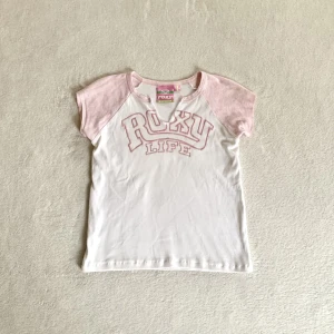 Babytee - Söt rosa/vit baseball-babytee med en liten cutout i urringningen, från märket Roxy! Står stl 4 och skulle säga att det är som en XS/S 💛