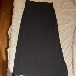 En helt oanvänd mörkgrå kjol med slits på höger sida av kjolen! 