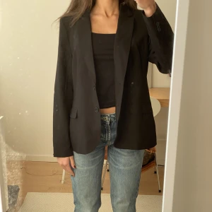 Svart blazer  - Svart blazer från STOCKH LM. Det står storlek 44 men min storlek är i vanligafall 36 så denna sitter lite oversized. Fraktar för 59kr eller möts upp i Lund. 