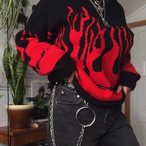 Ball stickad tröja  - Oversized Svart stickad tröja med eldslågor i rött. Andvänd skonsamt ett fåtal gånger så är i mycket fint skick.   Storlek L