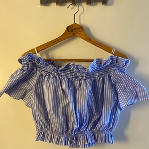Somrig crop top - Blå/vit randig off shoulder crop top från Zara. Strl M. Använd 1 gång