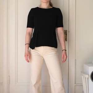 Svart blus/t-shirt, storlek 34 - Svart linne/t-shirt från H&M i storlek 34. Refflat material, se bild 2. Säljer då den är lite för liten för mig. Modellen på bilden är 160 cm. 