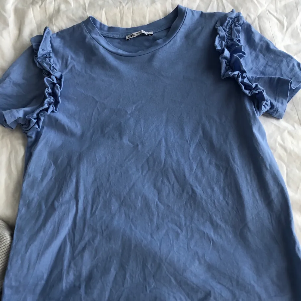 Söt blå Tshirt-topp från Zara med volanger på axlarna💕storlek M men passar S också! Använd fåtal gånger!. T-shirts.