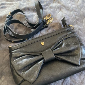 Kuvertväska - Liten söt väska från disneystore. Tillhörande axelband om man inte vill hålla den i handen.