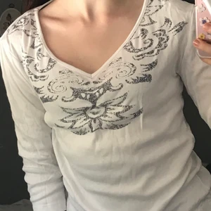 My Wear graphic print white top Size S - The top has a few signs of use. It has a few spots though they are barely visible.