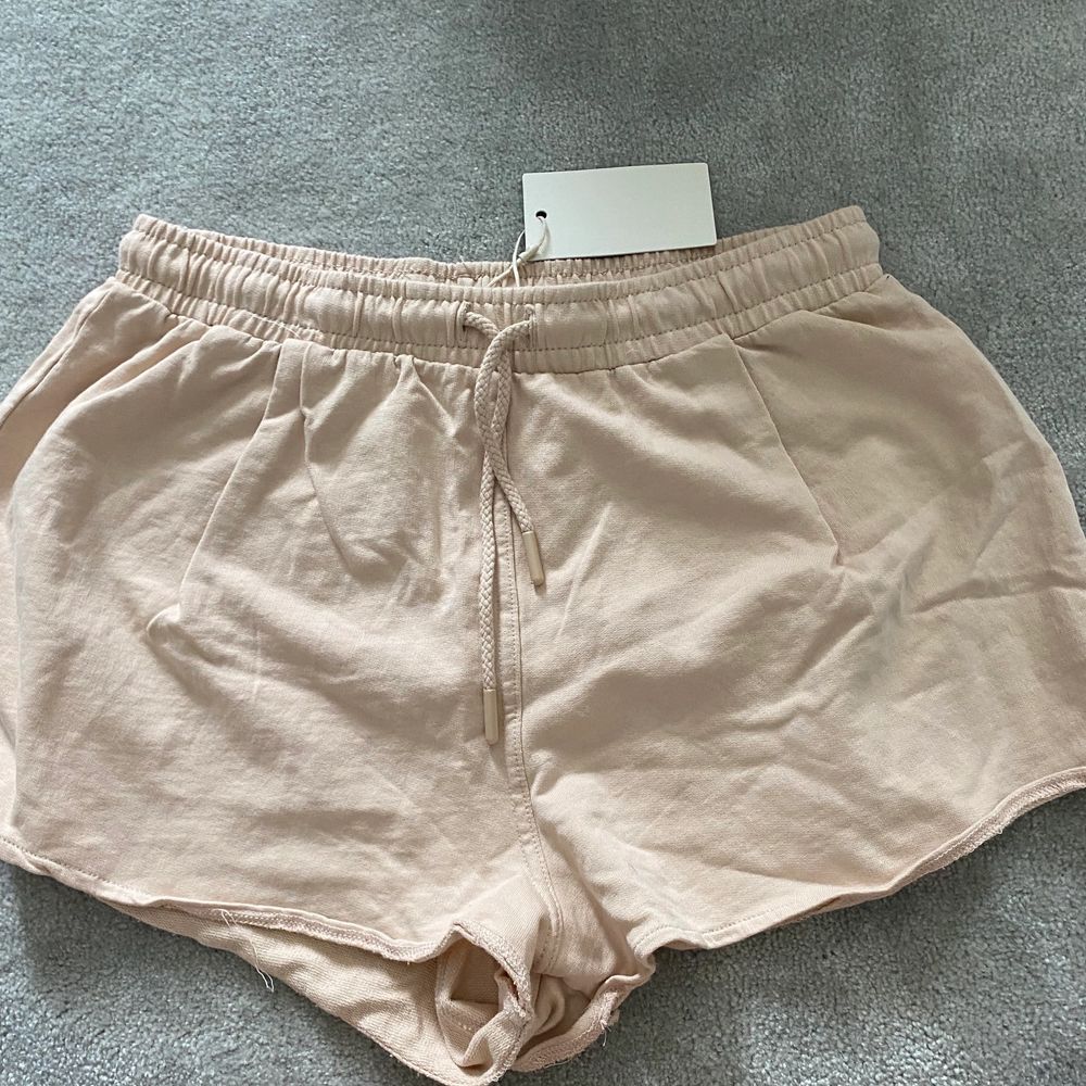 Dessa shorts som ni kan se är lappen kvar på, dom är oanvända! Färgen är beige/ rosa. Luftiga shorts som är perfekta till sommaren. Storleken är lite oklar då man kan ha dom från XS upp till M beroende på hur tajt man vill ha dom!. Shorts.
