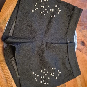 Lilyjlondon oanvända med lapp kvar - Superfina helt oanvända shorts med pärlor och mönster på 😍 Fin djup svart färg Mätt innermåt 77,5 cm från hake till fäste.