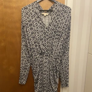 Klänning - Klänning från Michael Kors i tunnt material. Smickrade passform med en söm runt midjan. 