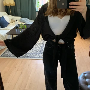 Kort kimono - En kort kimono i siden-aktigt tyg. Knyts framtill men kan även lämnas öppen. Den är storlek S men rätt så oversize ☺️ Knappt använd! 