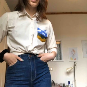  - En ljusbeige skjorta från Hm som jag målat på, på bröstfickan! Köparen står för frakten🥰